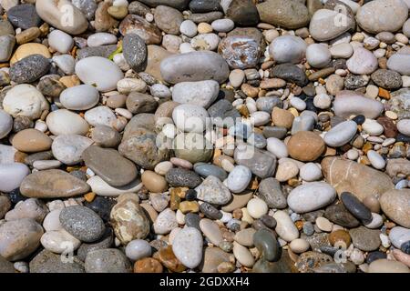 Close up on pebbles on a shore in Agios Gordios town on a Greek Island of Corfu Stock Photo