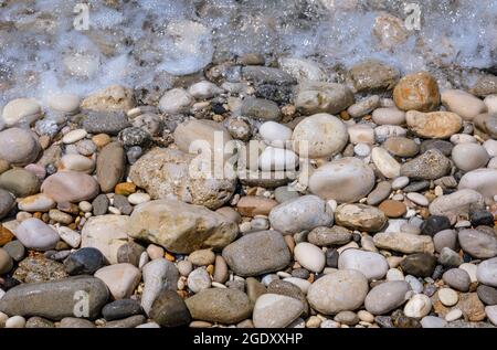 Close up on pebbles on a shore in Agios Gordios town on a Greek Island of Corfu Stock Photo