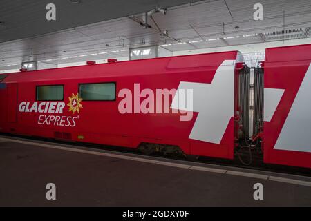 THUSIS, SWITZERLAND - APRIL 13, 2011: The glacier express from Zermatt to St.Moritz, panoramic train that crosses Alps. Stock Photo