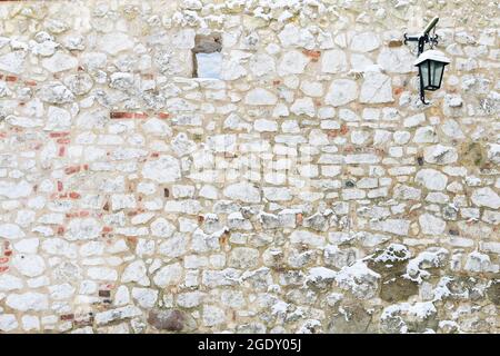 Stone wall with iron lantern and a little window. Graphic resources Stock Photo
