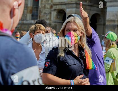 Braunschweig, Germany, August 14, 2021: Blonde policewoman with a face mask in the colors of the rainbow at CSD Christopher Street day Stock Photo