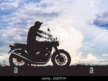 black shadow classic motorbike beautiful sunset sky background Stock Photo