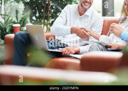 businessman and businesswoman shaking hands during a meeting . Stock Photo