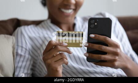 Close up of ethnic woman shopping online on cell Stock Photo