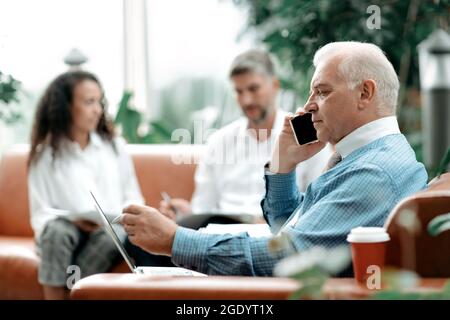 business man using a smartphone to clarify the necessary informa Stock Photo