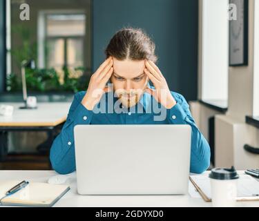 Focused male company employee trying to concentrate Stock Photo