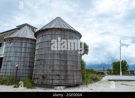 Port Boca Grande Lighthouse and Museum on Gasparilla Island as a tropical storm with black clouds looms off the coast in the Gulf of Mexico Stock Photo