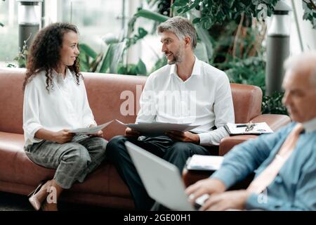 businessman and businesswoman discussing business and financial documents . Stock Photo
