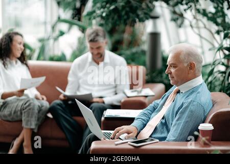 business man using a laptop to check financial data . Stock Photo