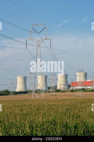 Nuclear power plant with field of Maize or Corn in front of it. Nuclear power station. Cooling towers. Mochovce. Slovakia. Stock Photo