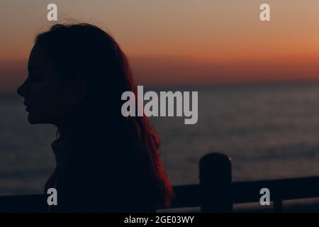 Young beautiful woman profile portrait at sunset Stock Photo
