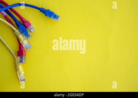 Ethernet cables isolated against yellow background Stock Photo