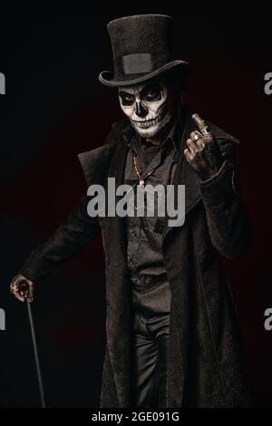 A young man in image of Baron Samedi, the Voodoo deity. Baron Saturday ...