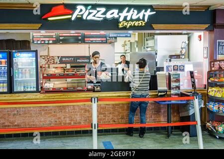 Miami Florida,International Airport MIA,terminal concession Pizza Hut Express restaurant,Black woman female counter cashier customer interior inside, Stock Photo