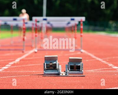 Obstacle course training. Athletics Starting Blocks and red running tracks in a stadion Stock Photo