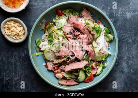 Thai style beef salad with cucumber and peanuts Stock Photo