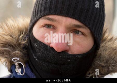 Close-up portrait of a fitter in a black comforter on his head Stock Photo