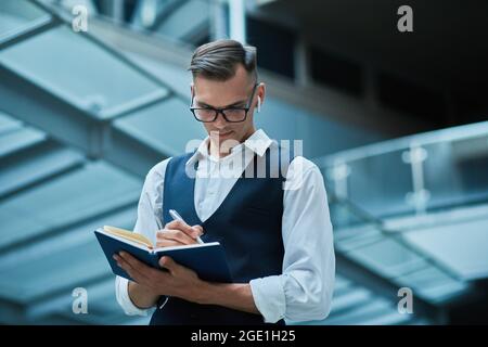 business man making notes in a notebook . Stock Photo