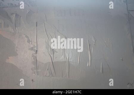 glued wall white poster paper with air pockets and bumpy uneven application Stock Photo