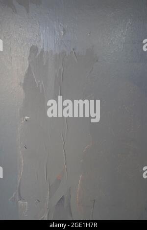 glued wall white poster paper with air pockets and bumpy uneven application Stock Photo