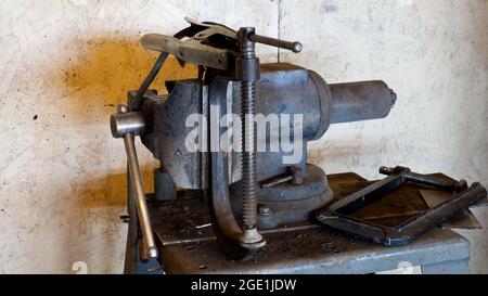 A Bench Vice, C Clamp, and Welding Ground Clamp in a Workshop Stock Photo