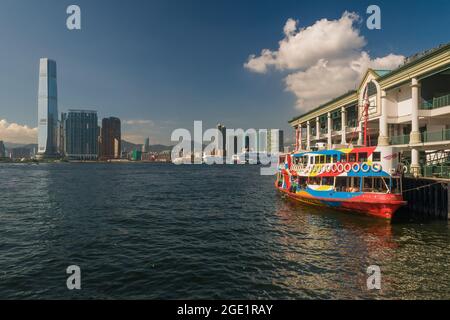 The 'Night Star', one of the Star Ferry fleet, moored at Central Ferry Pier 7 on Hong Kong Island, with the ICC and West Kowloon in the background Stock Photo