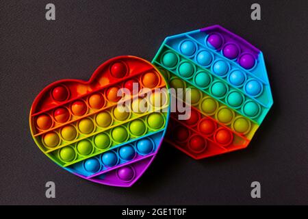 Colorful antistress sensory toy fidget push pop it on black background Stock Photo