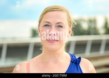 Close up of a thoughtful middle-aged woman looking quietly at the camera with a pensive smile Stock Photo