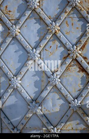 decorative wrought-iron elements on antique iron, rusty doors close-up Stock Photo