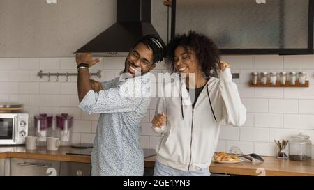 Happy African couple dancing together in modern kitchen Stock Photo