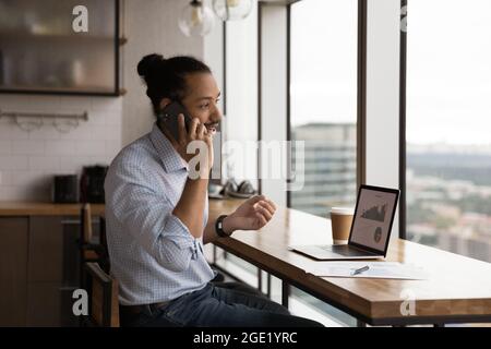 African businessman talks to client on phone analyzing sales growth Stock Photo