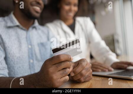 Happy African couple makes instant money transfer use online services Stock Photo