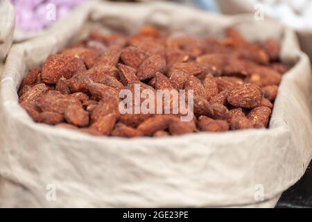 Assorted nuts in paper boxes for sale in the market. Selective focus. Stock Photo