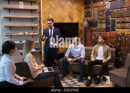 Multiracial employees listen to leader during meeting in office Stock Photo