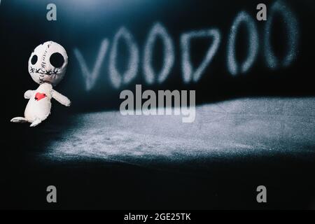 Voodoo magic ritual doll laying on a black background Stock Photo