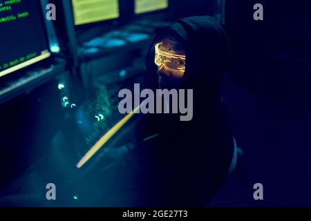 Cyber hacker breaks into databases to obtain information using a computer. Cybercrime and data security concept. Stock Photo