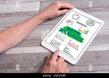 Data analysis concept shown on a tablet used by a woman Stock Photo