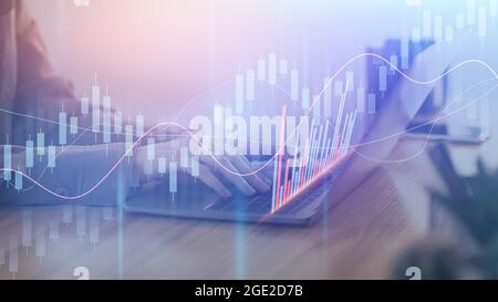 Businesswoman working on laptop with charts and graphs in office Stock Photo