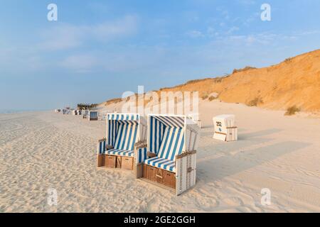 Beach chairs in front of the Rotes Kliff, a sea cliff near Kampen, island of Sylt, Schleswig-Holstein, Germany Stock Photo