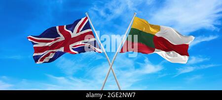 flags of great Britain and LITHUANIA and flag of Belarus  waving in the wind on flagpoles against sky with clouds on sunny day. Symbolizing relationsh Stock Photo