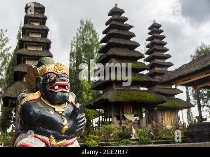 Black temple guard in the inner sanctum in front of Meru towers of the Ulun Danu Batur temple. Bali, Indonesia. Stock Photo