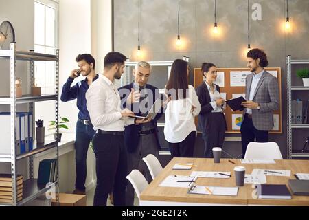 Busy company workers working on their projects in a modern office of their company Stock Photo