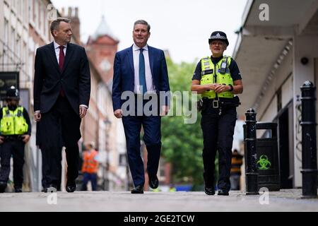 Labour leader Sir Keir Starmer and shadow home secretary Nick Thomas-Symonds (left) accompany a police officer during a walkabout in the centre of Wolverhampton. Picture date: Monday August 16, 2021. Stock Photo