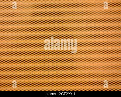 detail of an orange texture with perforated holes Stock Photo