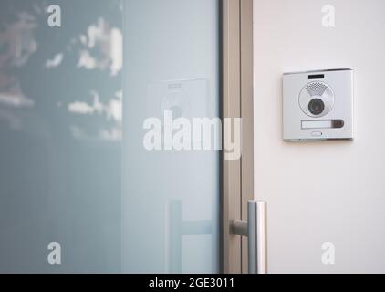detail of an entrance door to a house with a doorbell with camera Stock Photo