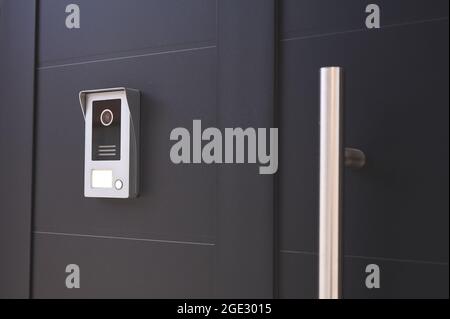 detail of an entrance door to a house with a doorbell with camera Stock Photo