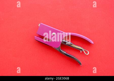 Pink stapler isolated on pink background. Top view, copy space, flat lay. Stock Photo