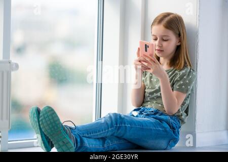 Preteen girl with smartphone Stock Photo