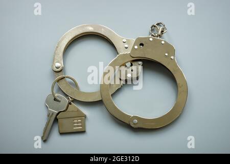 Handcuffs and house keys. Rent or mortgage relief concept. Stock Photo