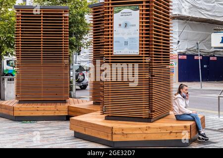 Cork, Ireland. 16th Aug, 2021. The controversial robot trees installed in Cork City centre made the perfect place to stop for a cigarette today. Credit: AG News/Alamy Live News Stock Photo